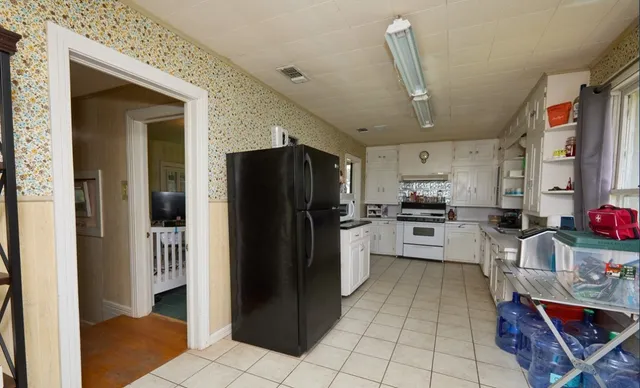 a kitchen with a refrigerator and cabinets