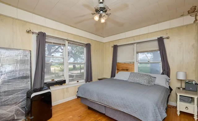 a bedroom with a large bed and a window