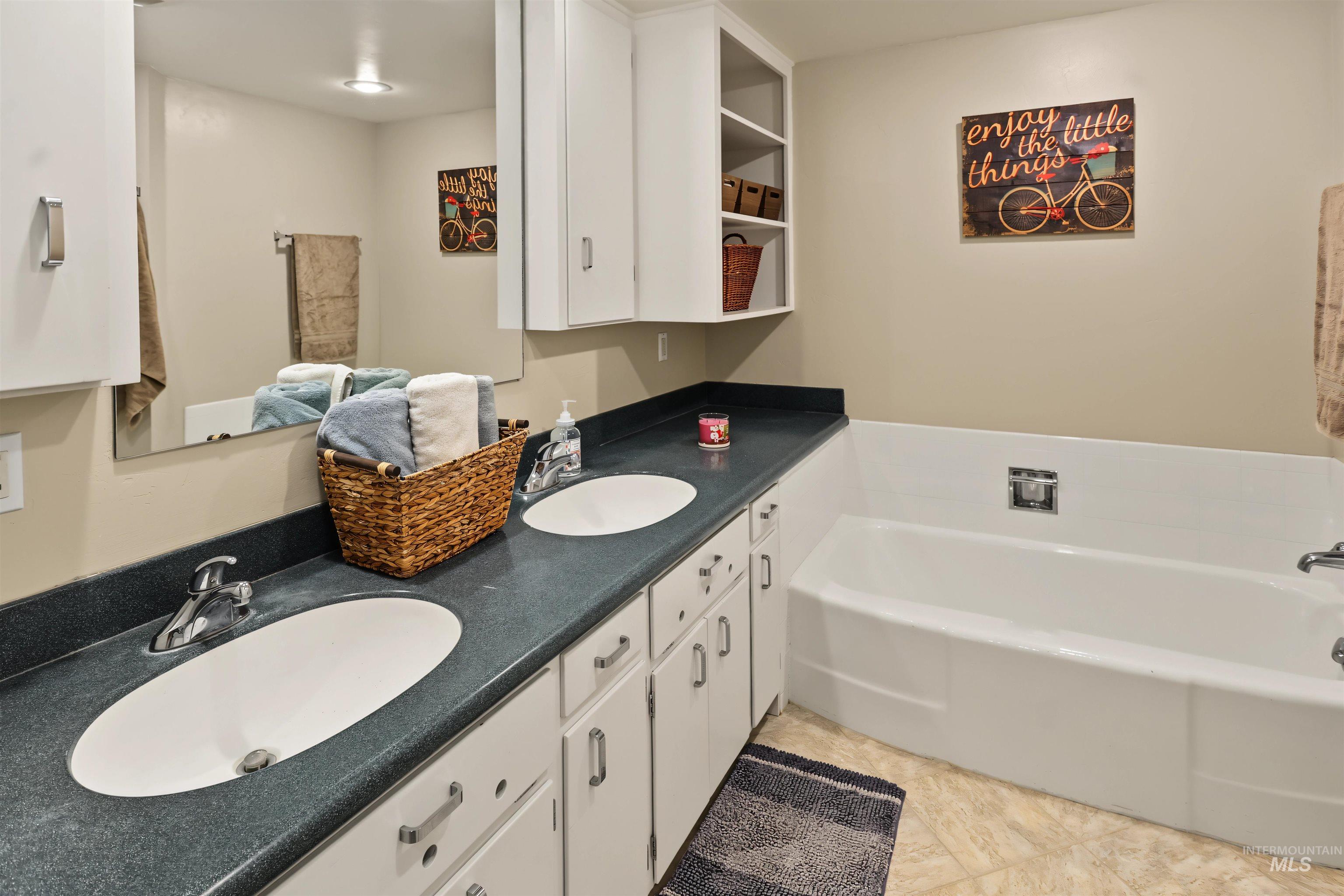 508 East Elm Avenue Parma, ID 83660 - Photo 28 of 50 Dual vanity with undermount sinks, white cabinetry, and dark countertops
