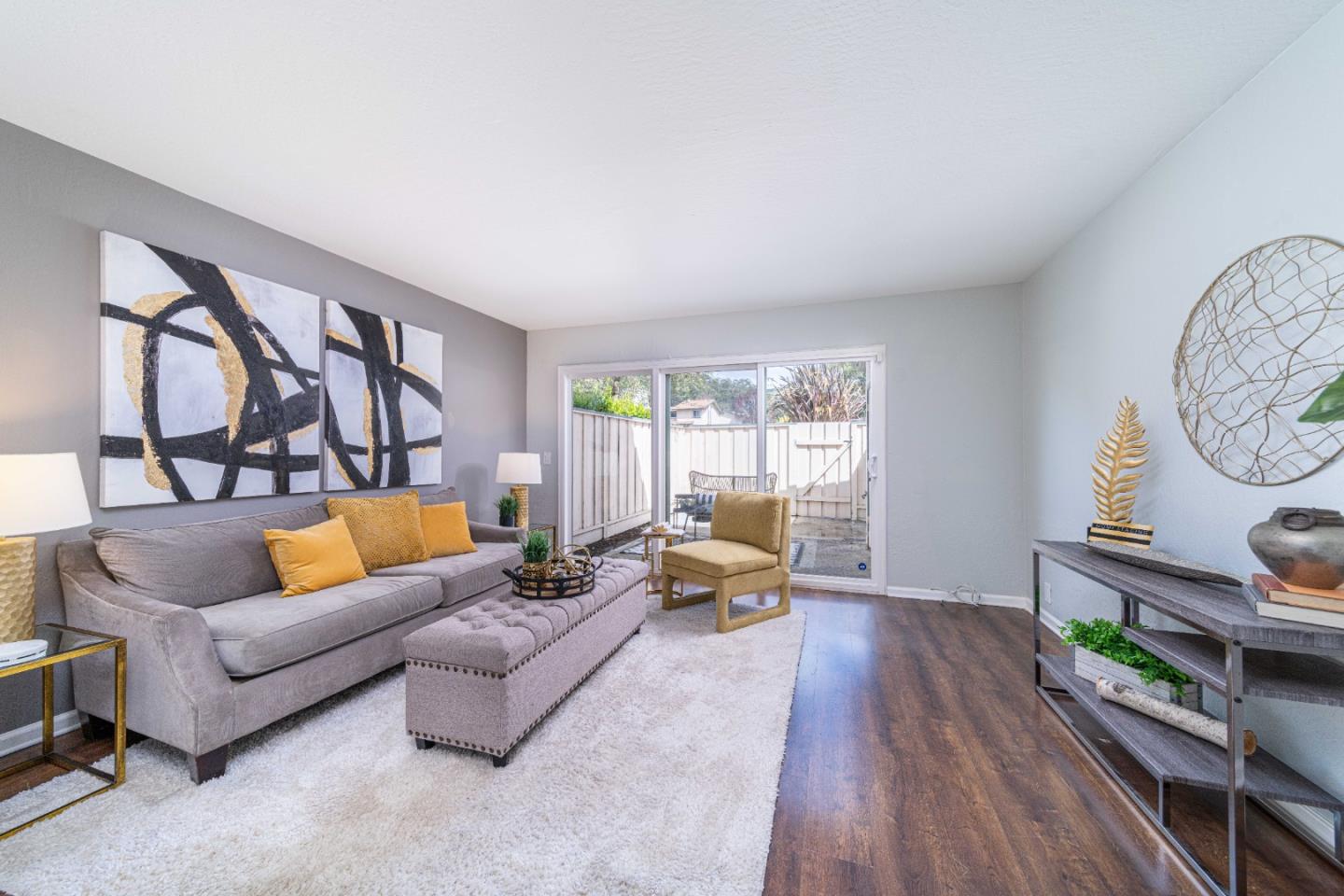 a living room with furniture and a wooden floor