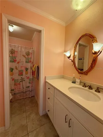 a en suite bathroom with a granite countertop sink and a mirror