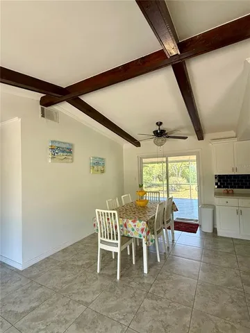 a dining room with furniture and window