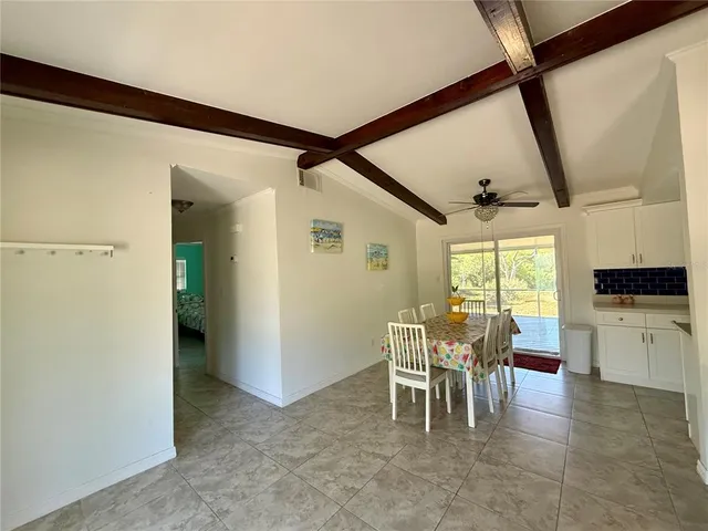 a dining room with furniture and entryway