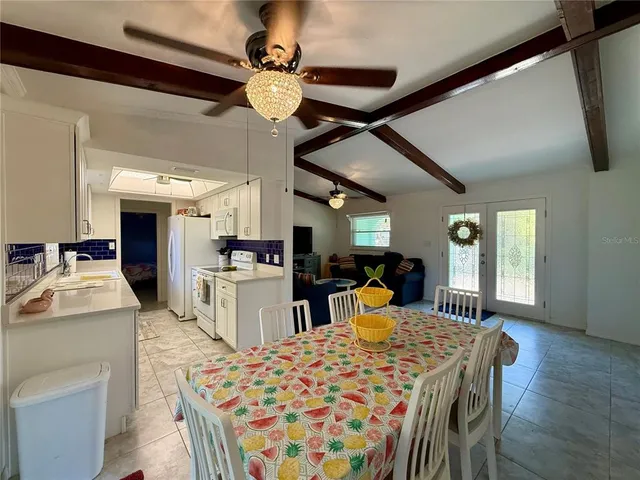 a large kitchen with a table and chairs