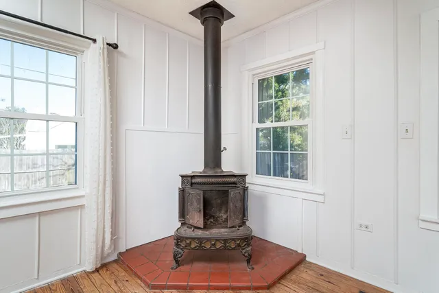 a living room with a fireplace and a window