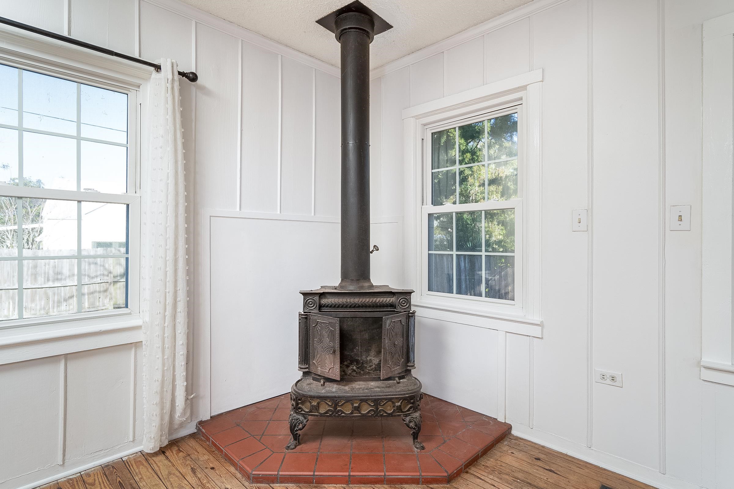 401 Zorayda Avenue St. Augustine, FL 32080 - Photo 11 of 41 a living room with a fireplace and a window