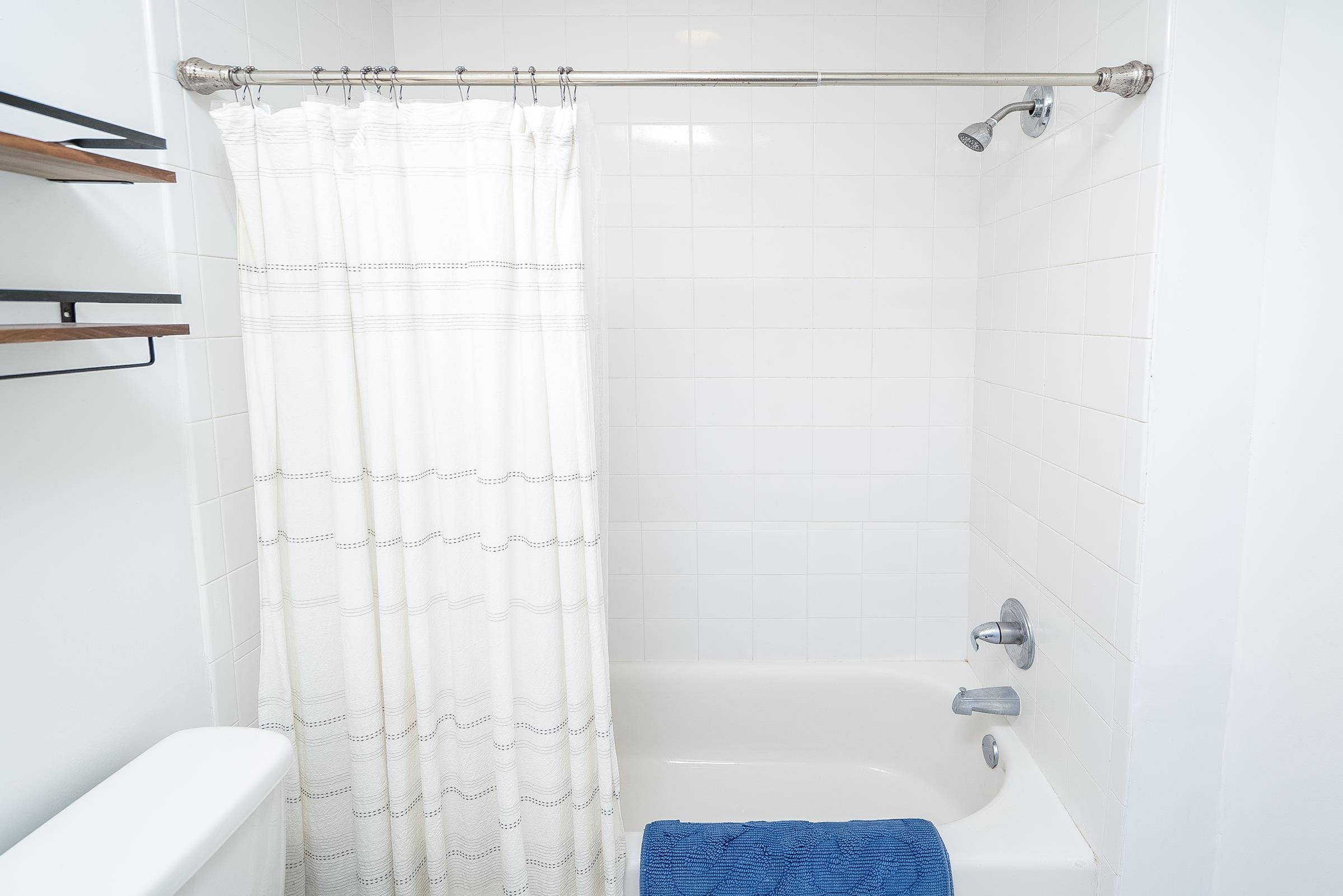 401 Zorayda Avenue St. Augustine, FL 32080 - Photo 22 of 41 a bathroom with a shower curtain and a bathtub