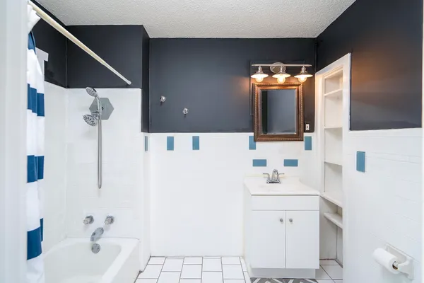 a bathroom with a bathtub and a shower