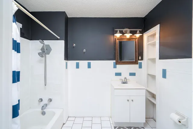 a bathroom with a bathtub and a shower