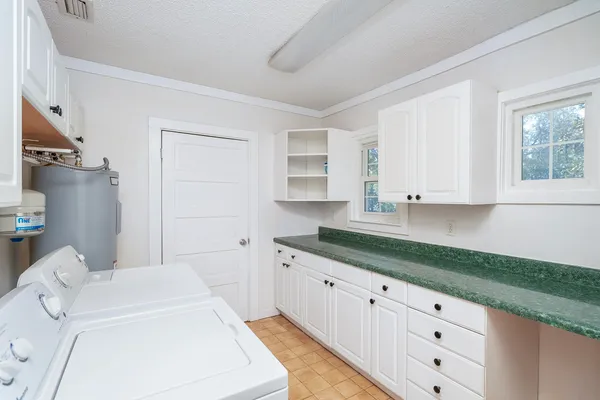 a bathroom with a granite countertop sink and a bathtub