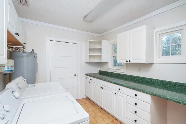 a bathroom with a granite countertop sink and a bathtub