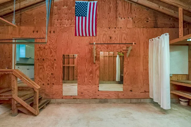 a front view of house with yard and trees around