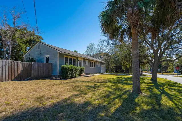 a view of a house with pool and trees