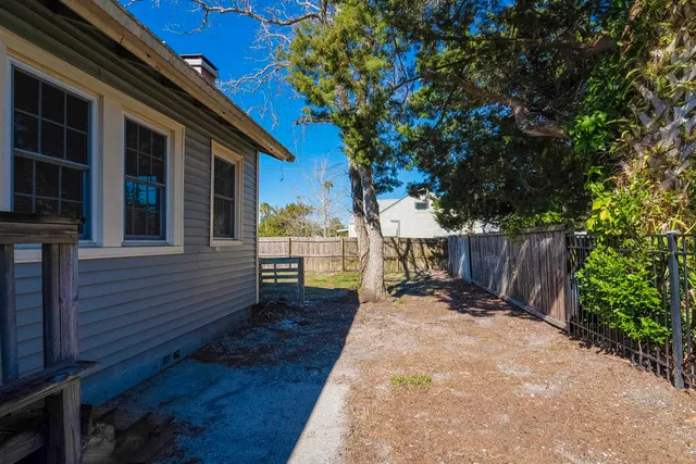 a backyard of a house with table and chairs