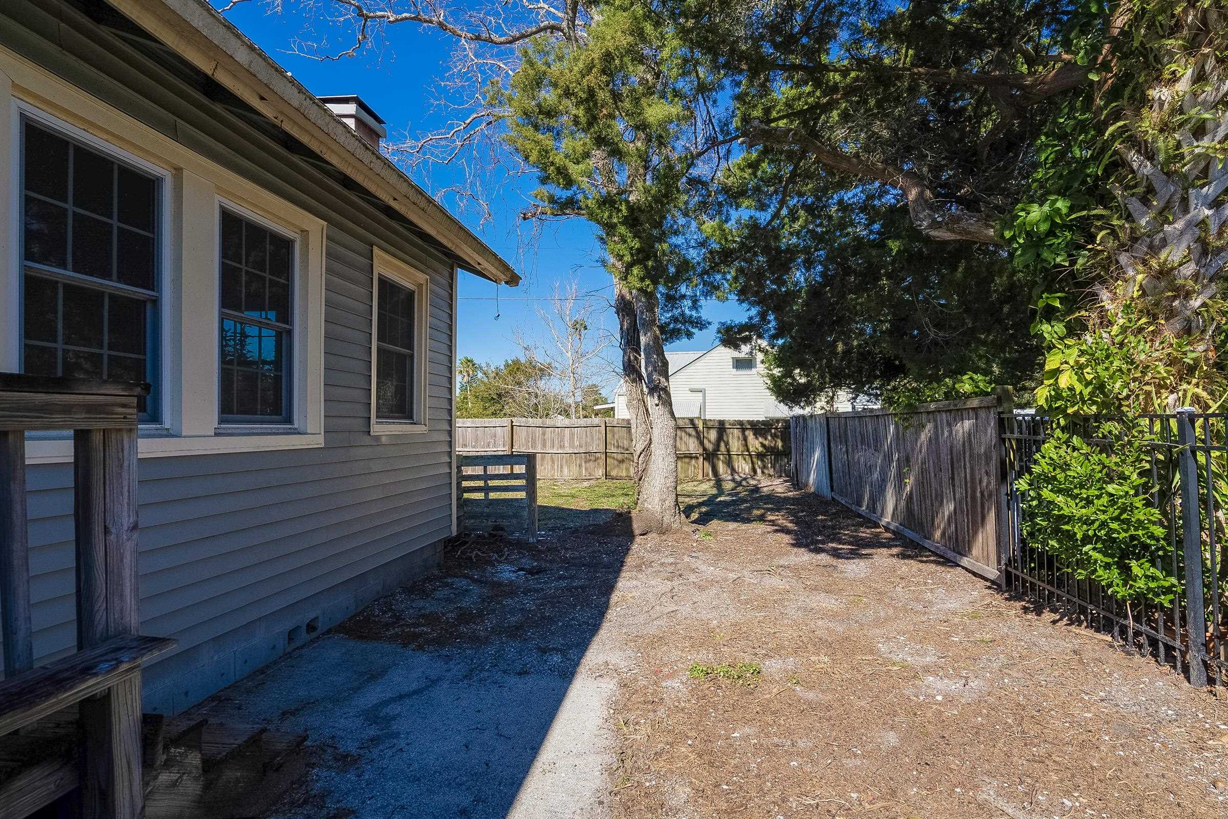 401 Zorayda Avenue St. Augustine, FL 32080 - Photo 40 of 41 a view of a backyard with wooden fence and a large tree
