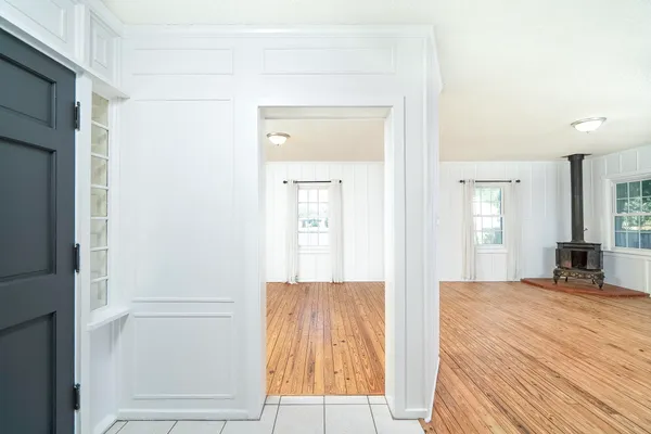 a view of a bedroom with wooden floor and windows