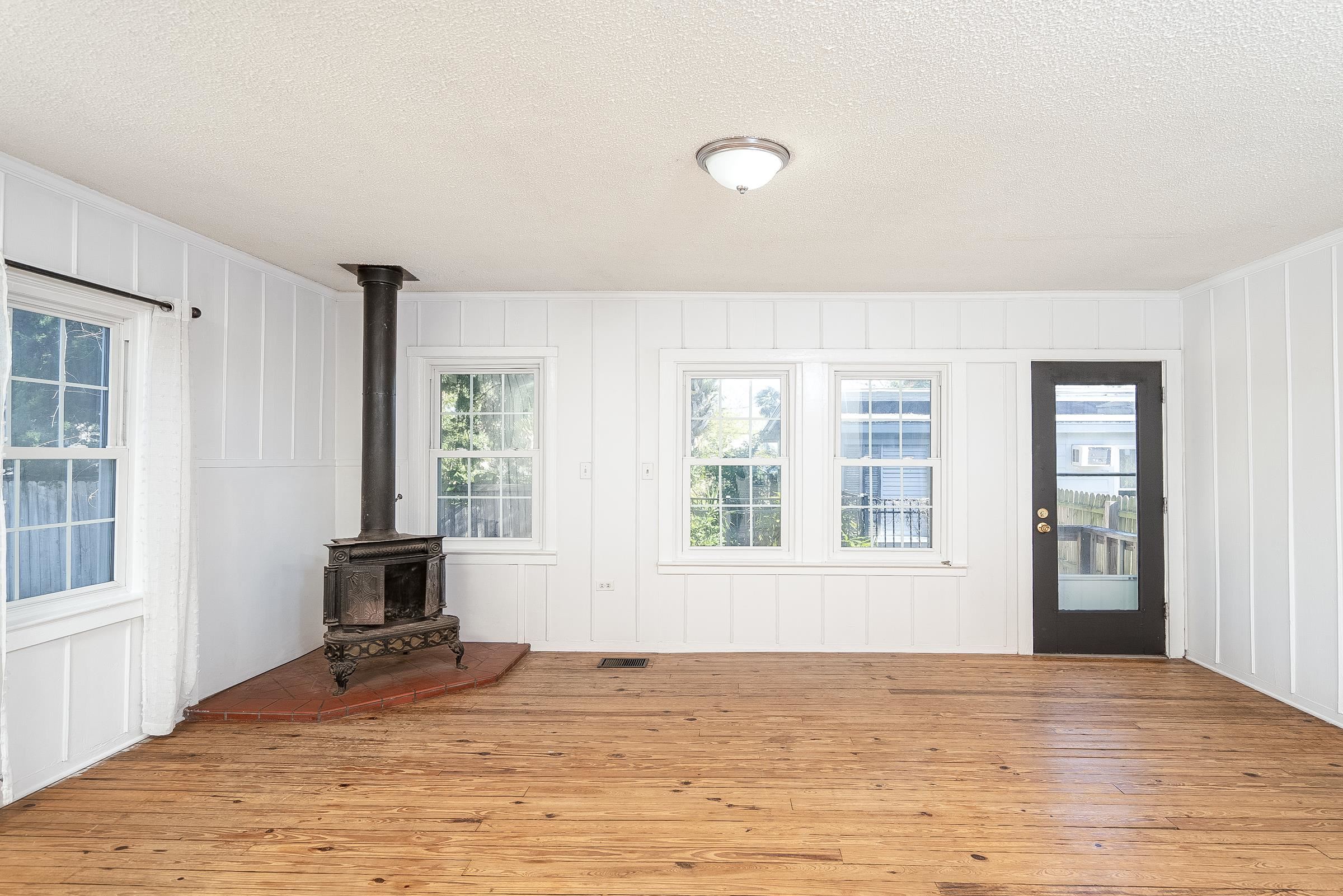 401 Zorayda Avenue St. Augustine, FL 32080 - Photo 8 of 41 a view of an empty room with a window and wooden floor