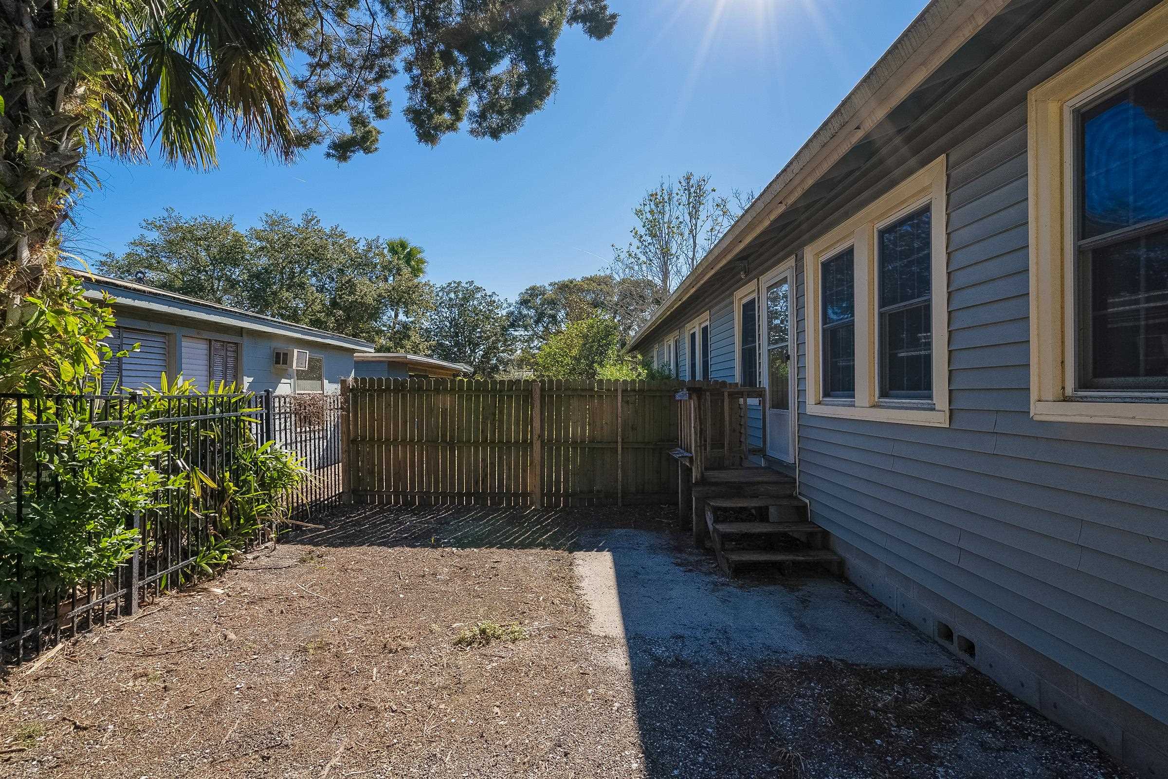 401 Zorayda Avenue St. Augustine, FL 32080 - Photo 10 of 41 a view of a house with a small yard plants and large tree