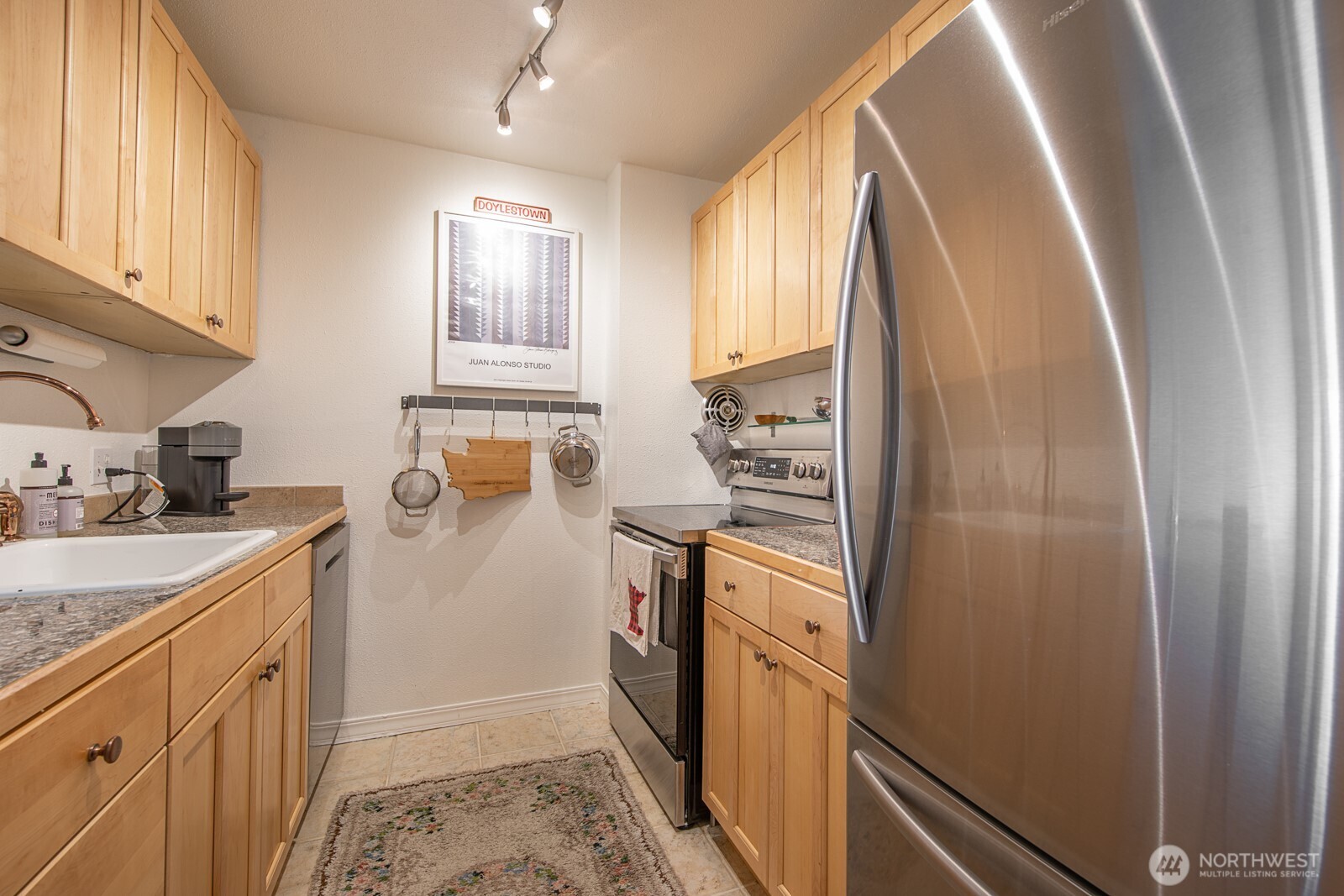 308 East Republican Street, Unit 508 Seattle, WA 98102 - Photo 13 of 27 a kitchen with stainless steel appliances granite countertop a refrigerator and a stove
