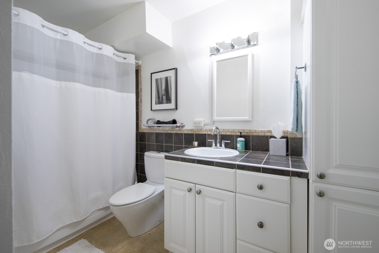 308 East Republican Street, Unit 508 Seattle, WA 98102 - Photo 19 of 27 a bathroom with a sink a toilet and mirror