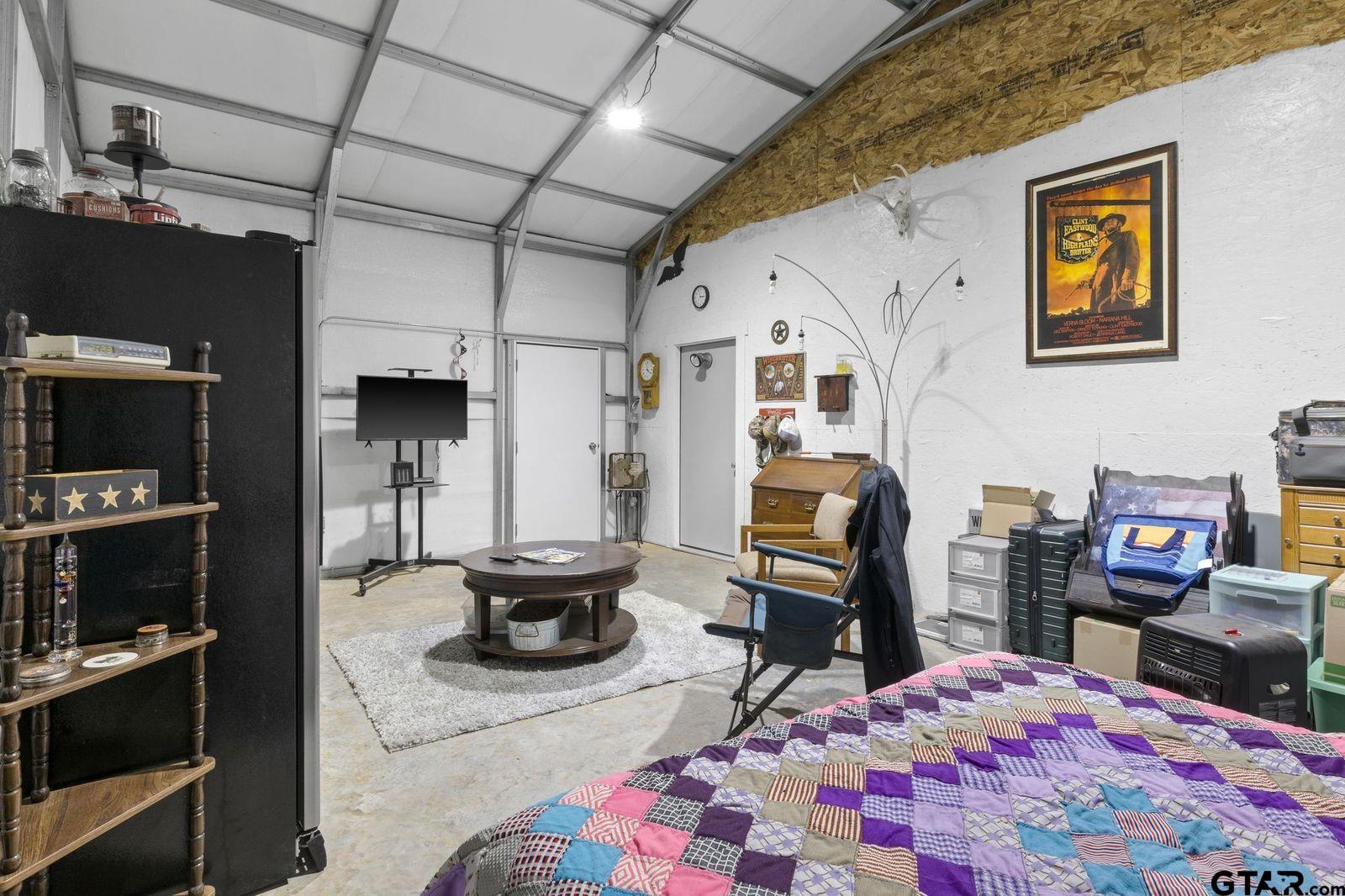 11501 Waterbuck Road Winnsboro, TX 75494 - Photo 8 of 29 a living room with furniture and a flat screen tv