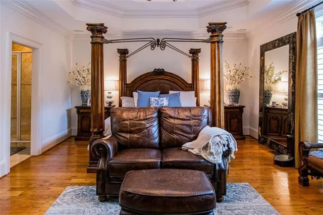 a bedroom with a bed and a chandelier