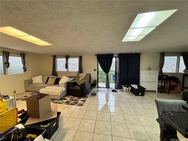 a living room with furniture a computer on the desk and chair