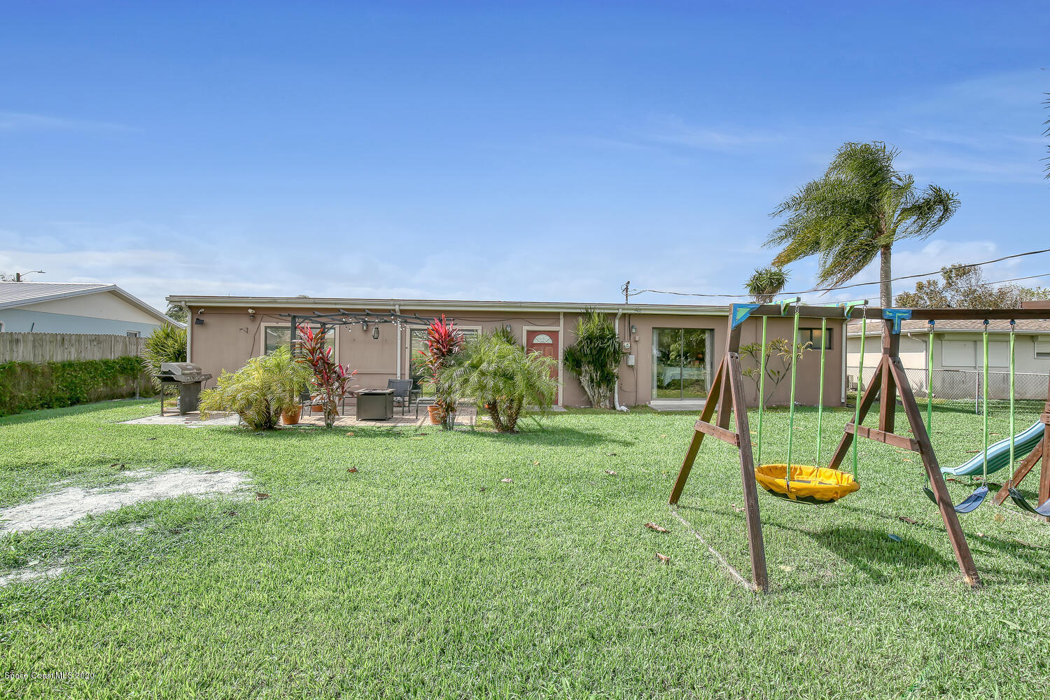 765 Angle Street Northeast Palm Bay, FL 32905 - Photo 33 of 42 Backyard with Playset Angle 3