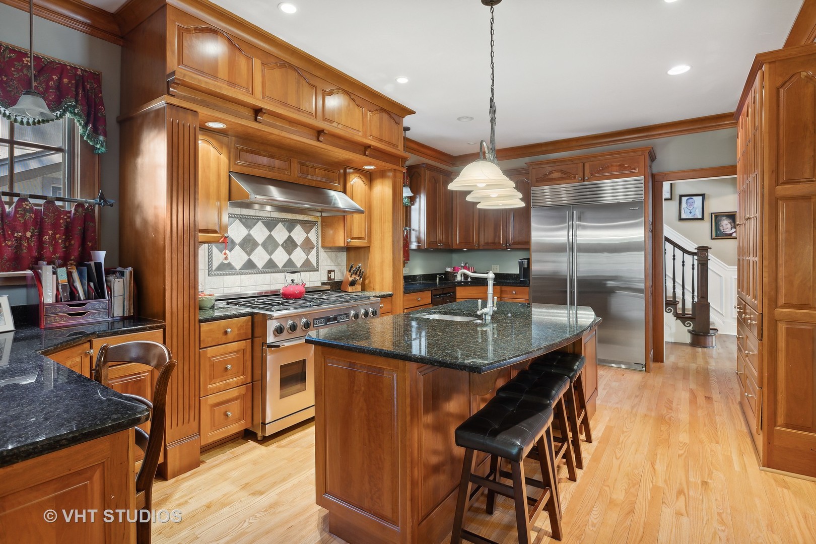 142 Akenside Road Riverside, IL 60546 - Photo 11 of 42 a kitchen with stainless steel appliances granite countertop a sink a stove and a wooden floors