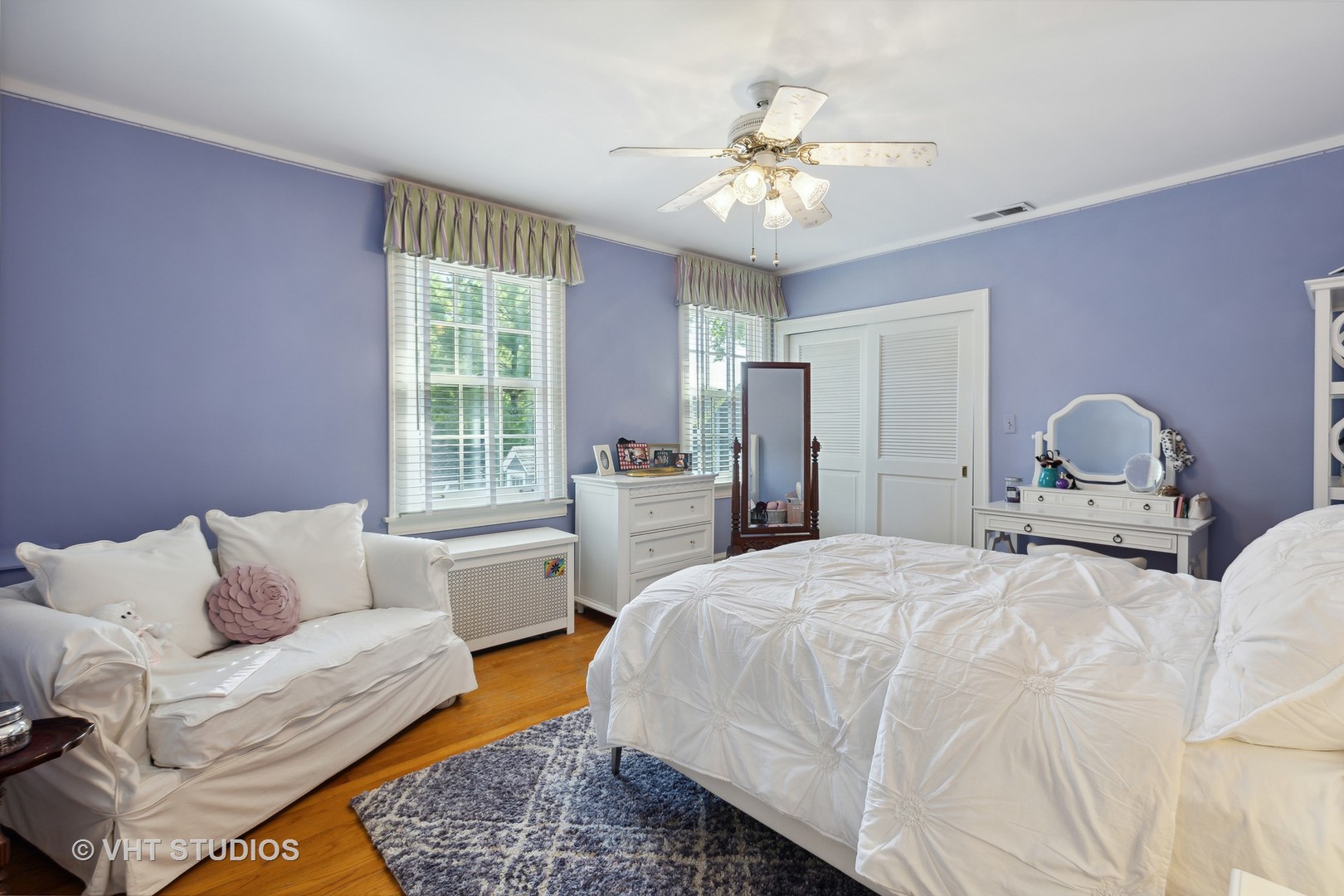 142 Akenside Road Riverside, IL 60546 - Photo 29 of 42 a bedroom with a bed couch chandelier and windows