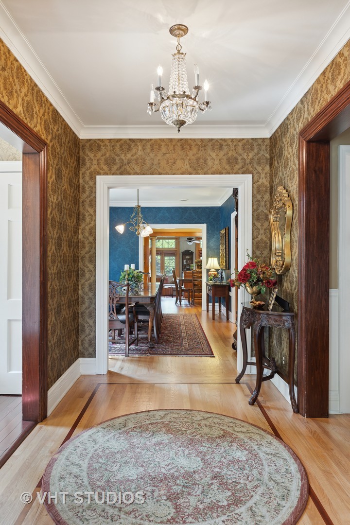 142 Akenside Road Riverside, IL 60546 - Photo 6 of 42 a view of a dining room with furniture a chandelier and wooden floor