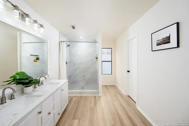 a bathroom with a sink and a shower