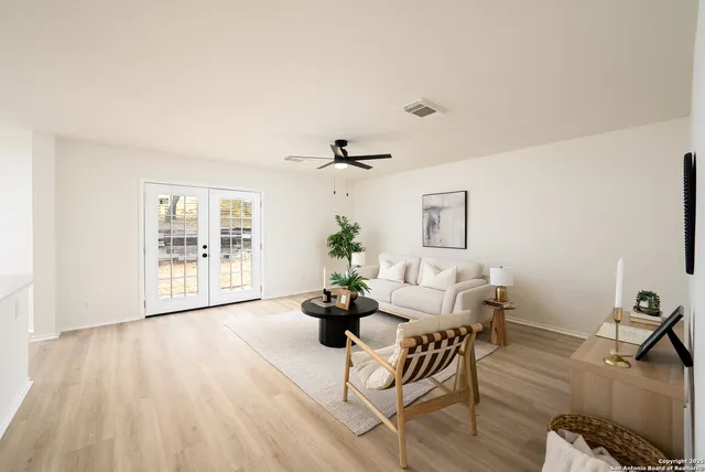 a living room with furniture and wooden floor