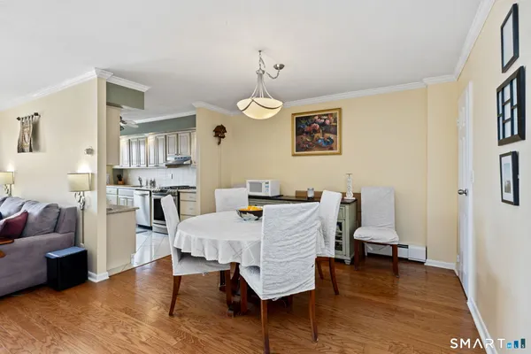 a view of a dining room with furniture and wooden floor