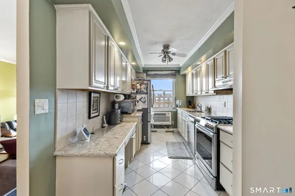 a kitchen with stainless steel appliances granite countertop a sink and stove