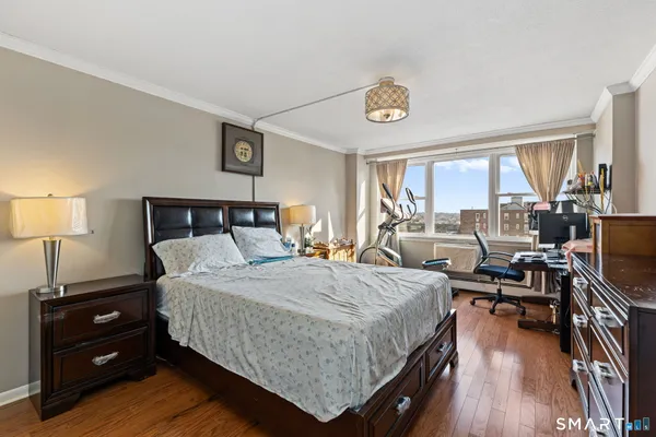 a bedroom with a bed and wooden floor