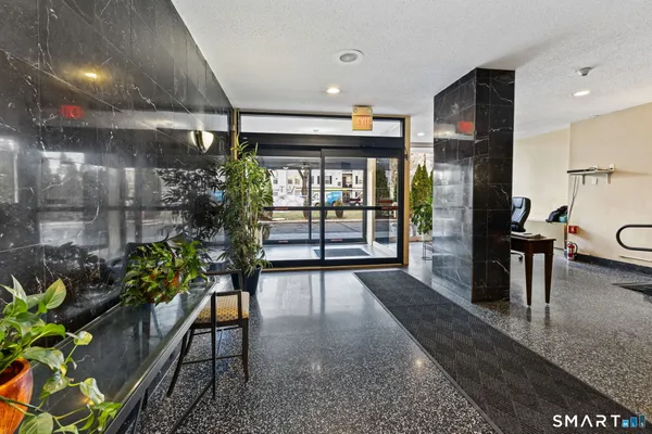 a lobby with furniture and floor to ceiling window