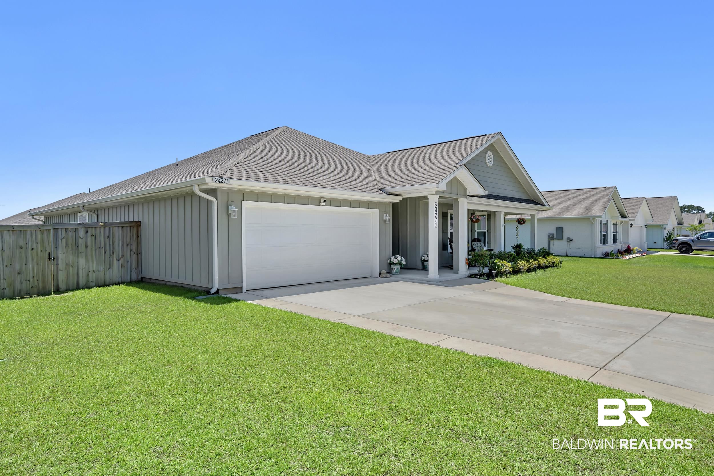 24271 Ringneck Loop Elberta, AL 36530 - Photo 38 of 44 Ranch-style residence featuring a prominent covered front porch, an attached garage, a concrete driveway, and a wooden privacy fence