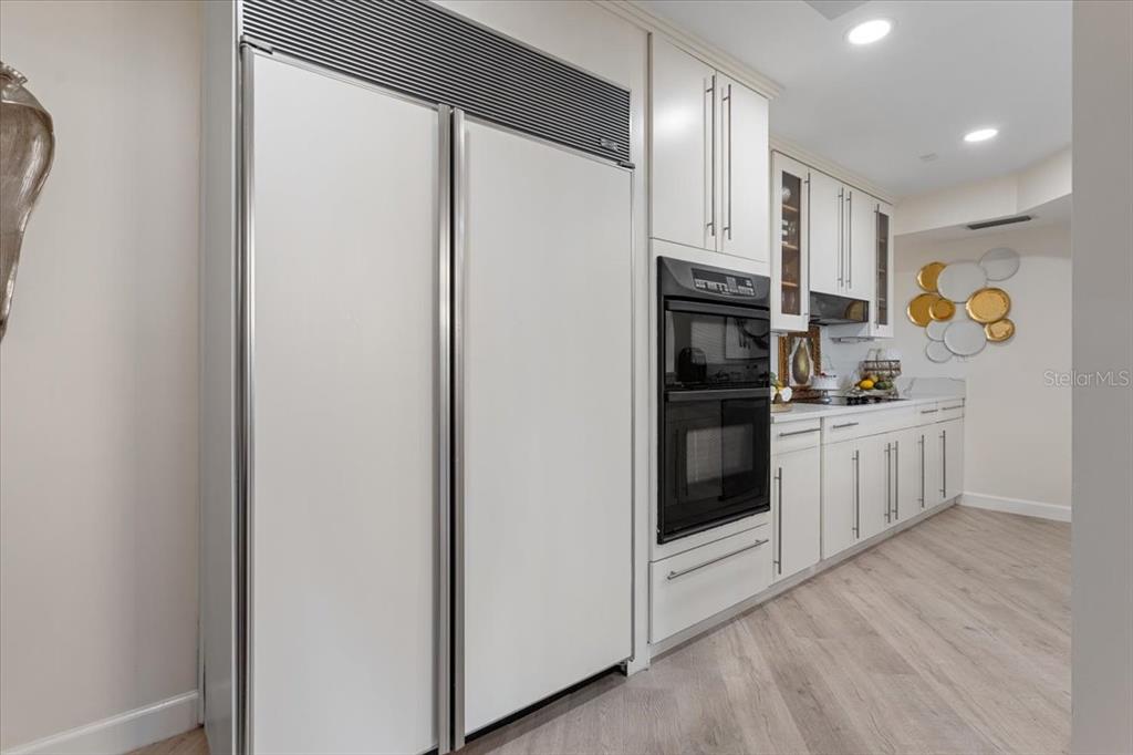 100 Southeast 5th Avenue, Unit 412 Boca Raton, FL 33432 - Photo 20 of 62 a kitchen with white cabinets and refrigerator