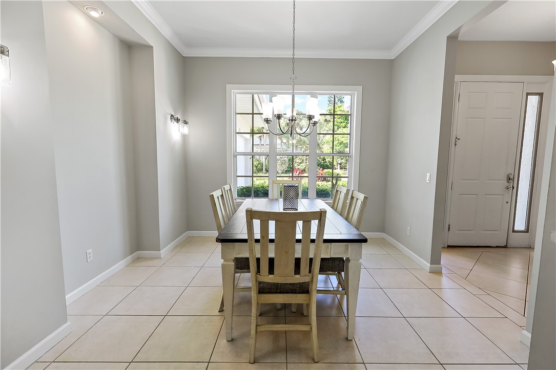 2038 Ocean Ridge Circle Vero Beach, FL 32963 - Photo 13 of 33 a view of a dining room with furniture and window