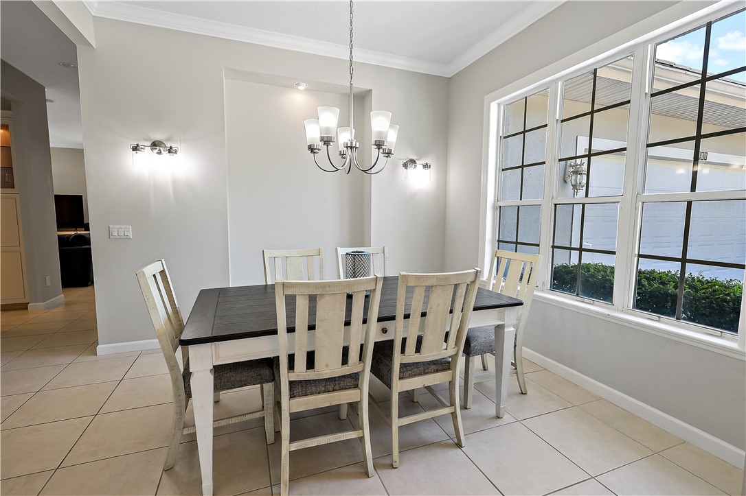 2038 Ocean Ridge Circle Vero Beach, FL 32963 - Photo 14 of 33 a view of a dining room with furniture and a chandelier
