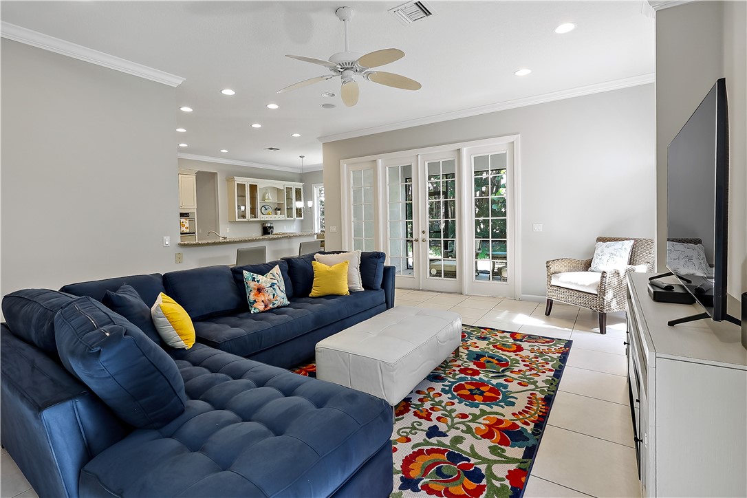 2038 Ocean Ridge Circle Vero Beach, FL 32963 - Photo 17 of 33 a living room with furniture fireplace and a flat screen tv