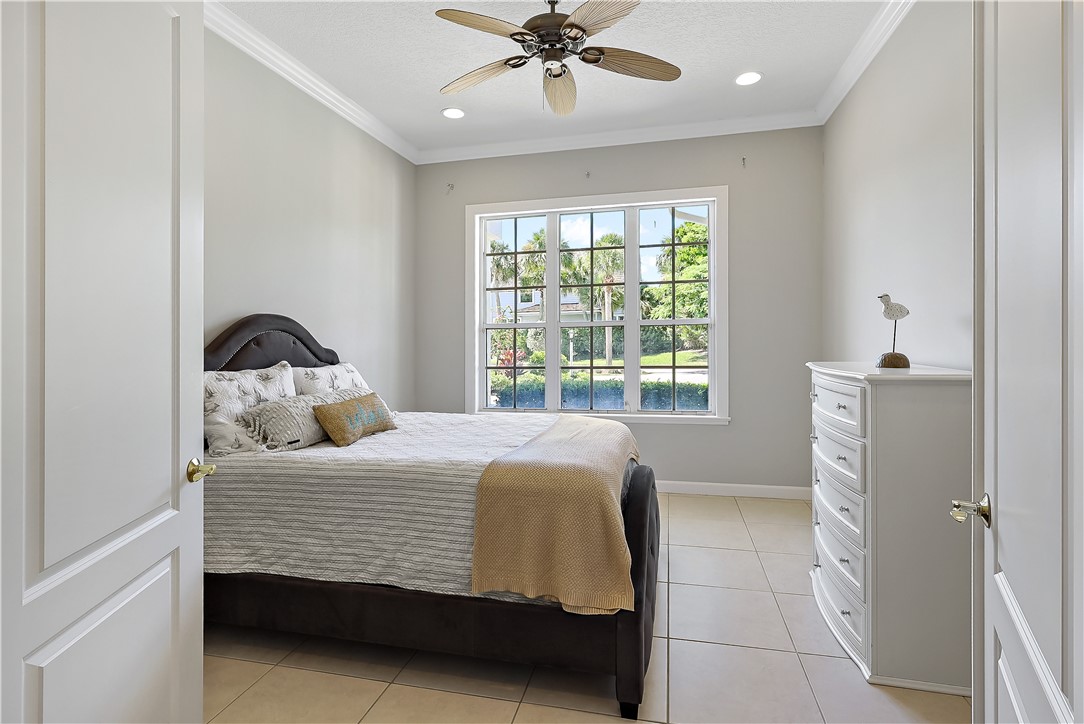 2038 Ocean Ridge Circle Vero Beach, FL 32963 - Photo 18 of 33 a bedroom with a bed and a window