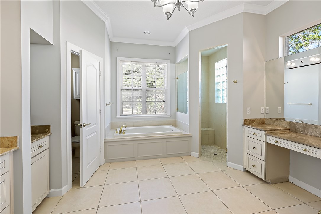 2038 Ocean Ridge Circle Vero Beach, FL 32963 - Photo 20 of 33 a bathroom with a tub sink and mirror