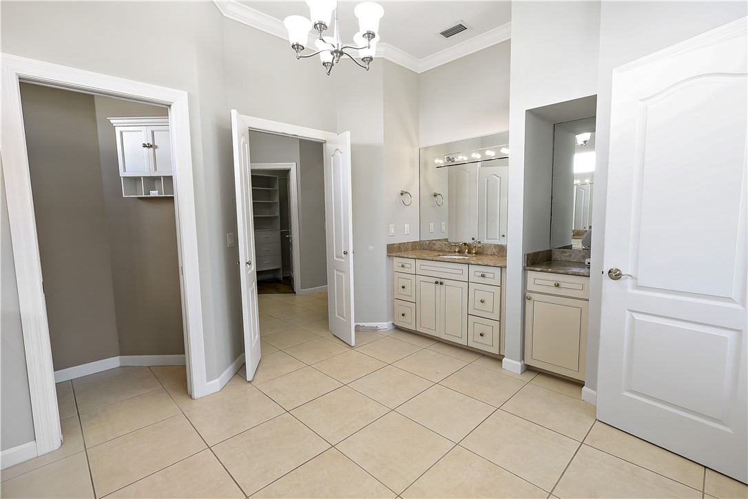 2038 Ocean Ridge Circle Vero Beach, FL 32963 - Photo 21 of 33 a view of a kitchen with white cabinets and sink