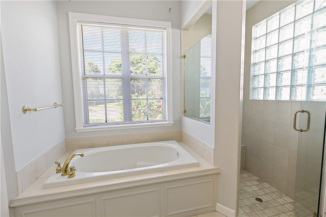 2038 Ocean Ridge Circle Vero Beach, FL 32963 - Photo 22 of 33 a bathroom with a tub a window and a shower