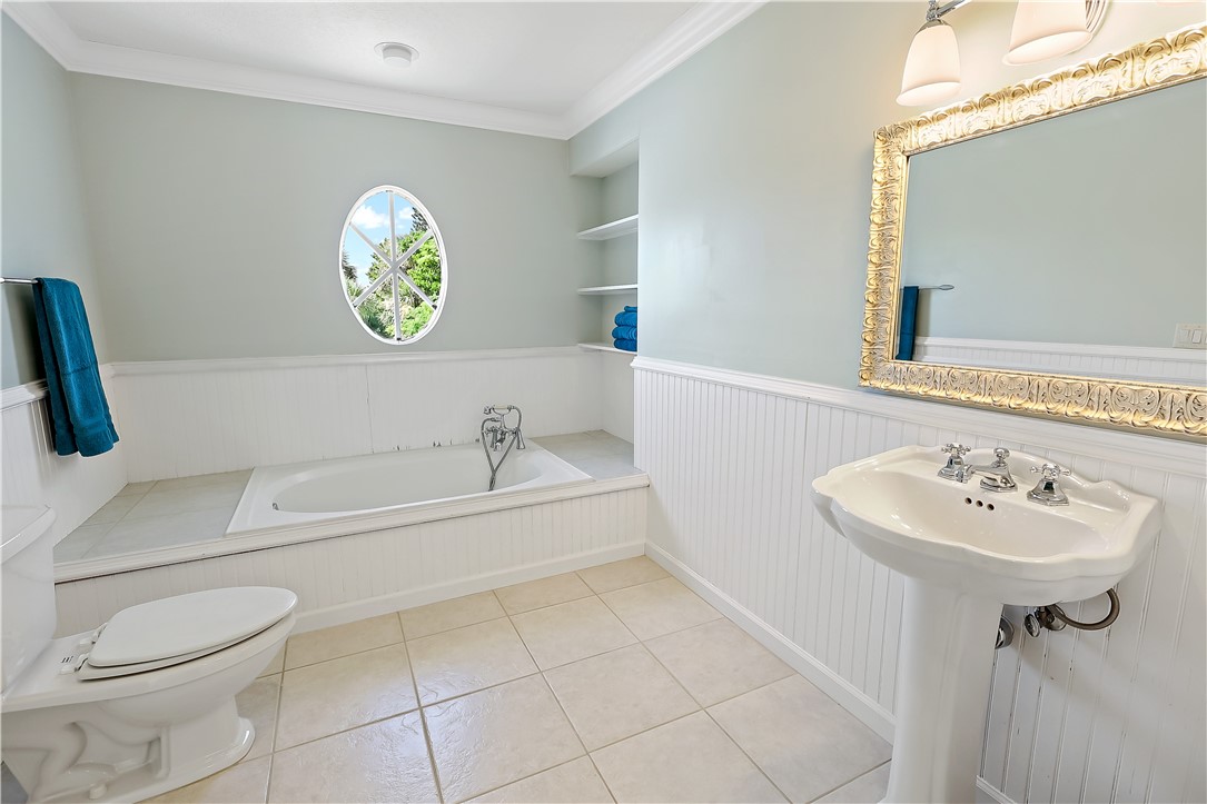2038 Ocean Ridge Circle Vero Beach, FL 32963 - Photo 31 of 33 a bathroom with a sink a toilet and a bathtub