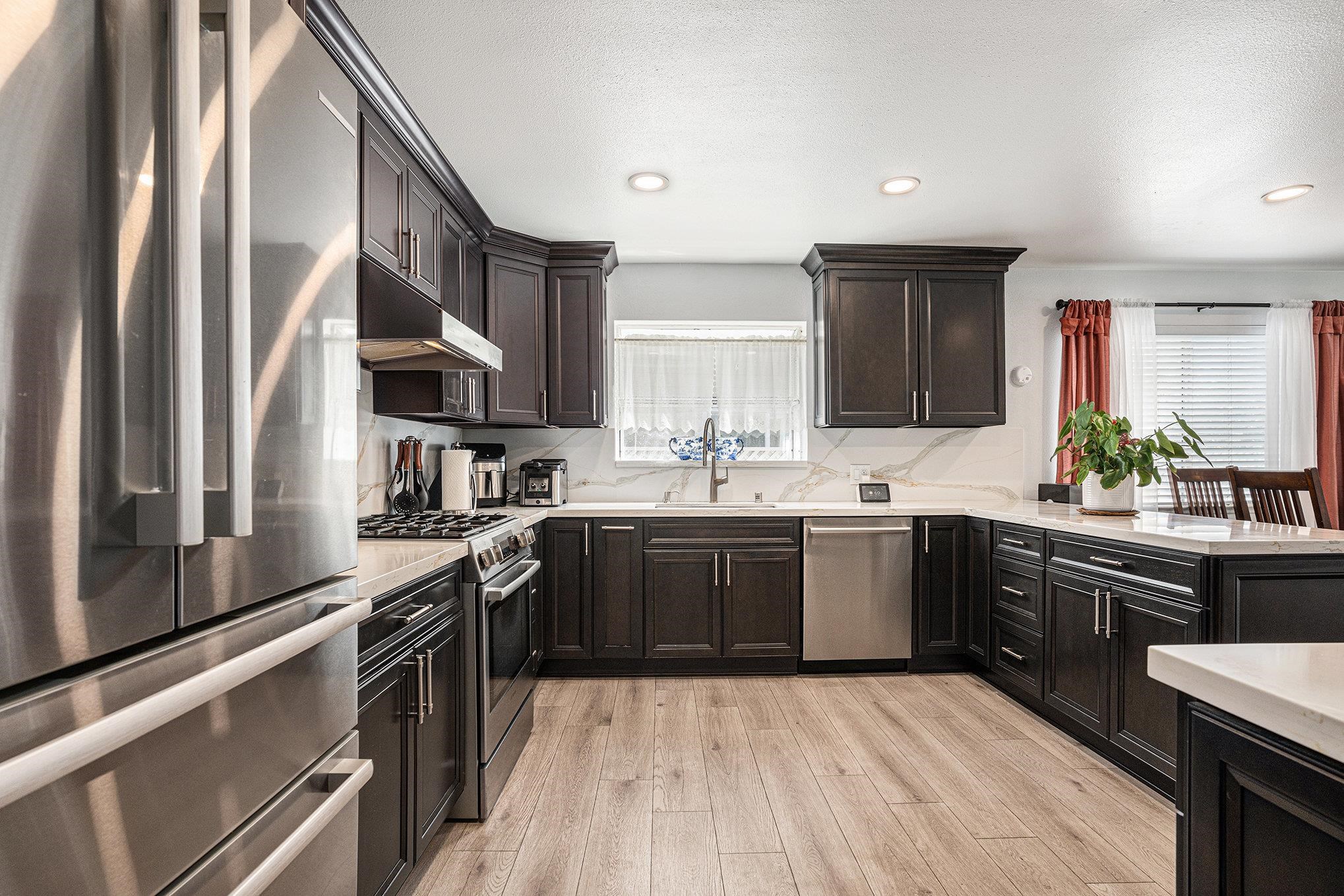 111 Overacker Terrace Fremont, CA 94536 - Photo 13 of 33 a kitchen with stainless steel appliances granite countertop a sink stove and refrigerator