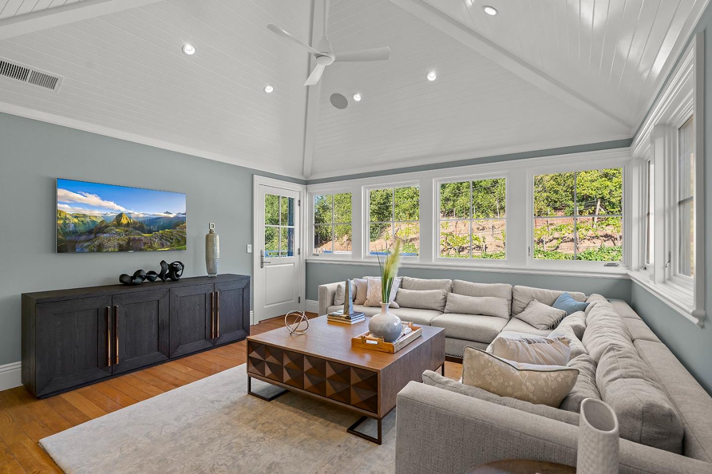 14966 Sobey Road Saratoga, CA 95070 - Photo 35 of 70 a living room with furniture a flat screen tv and a large window