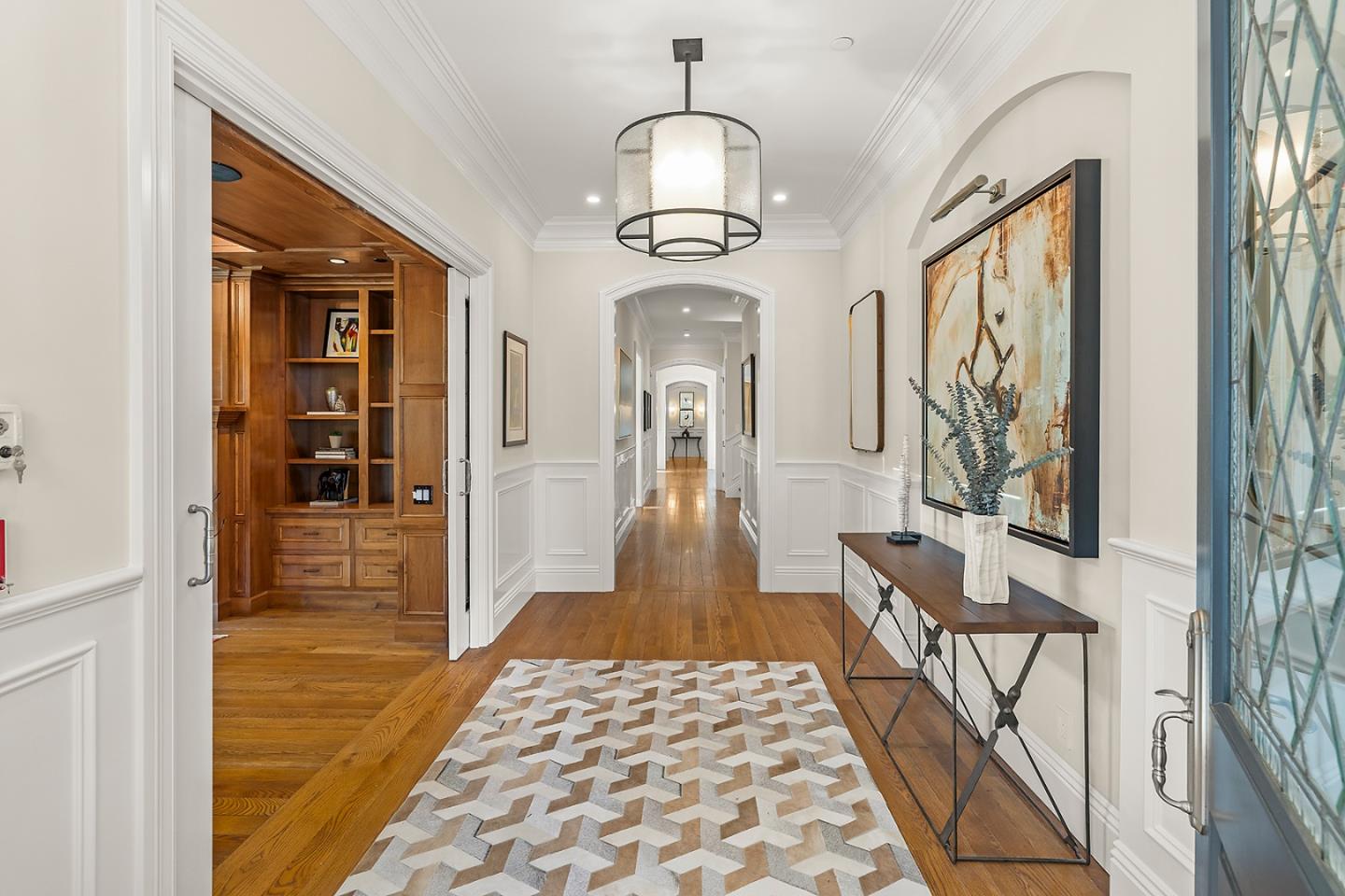 14966 Sobey Road Saratoga, CA 95070 - Photo 5 of 70 a view of a hallway with wooden floor windows and a chandelier